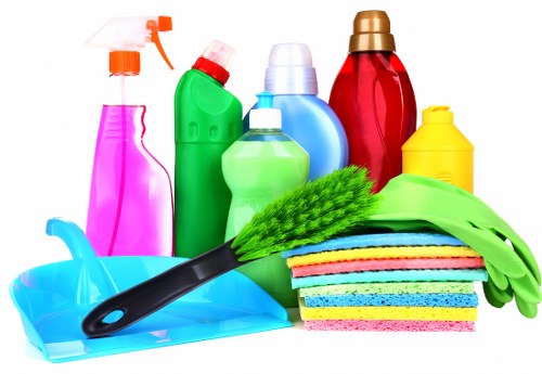 Professional home cleaner in Shepherds Bush tidying a modern living room