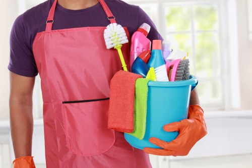 Office cleaner sanitising a meeting room in Shepherdsbush